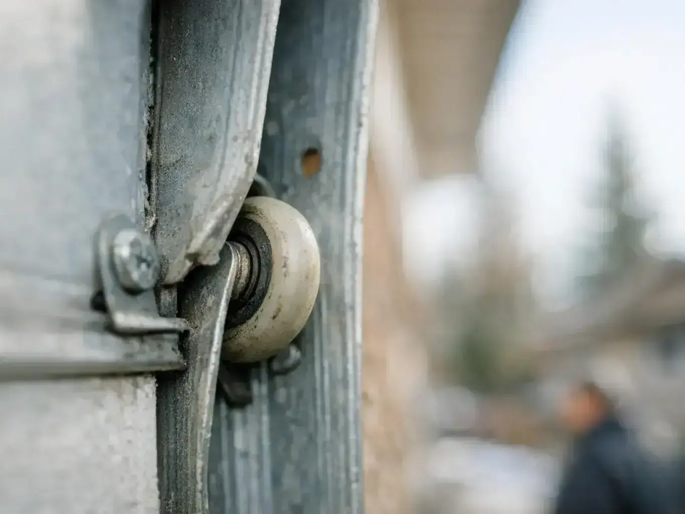 Close-up of garage door opener sensor alignment and safety testing